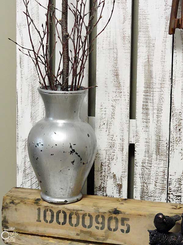 picket fence with rustic vase