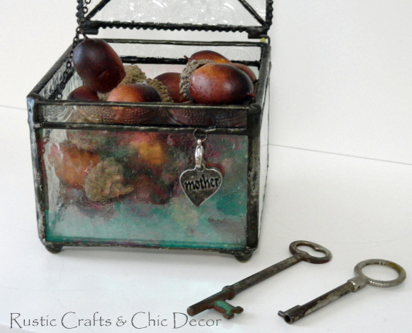 skeleton key next to pewter lined glass box with heart charm