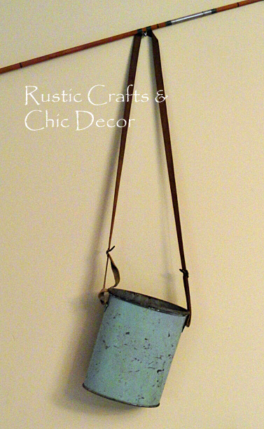 Antique fishing rods on a wooden wall with a wicker fishing basket and rope