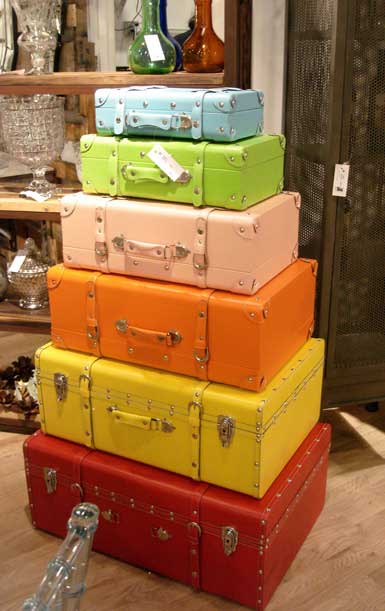 colorful painted stacked old suitcases