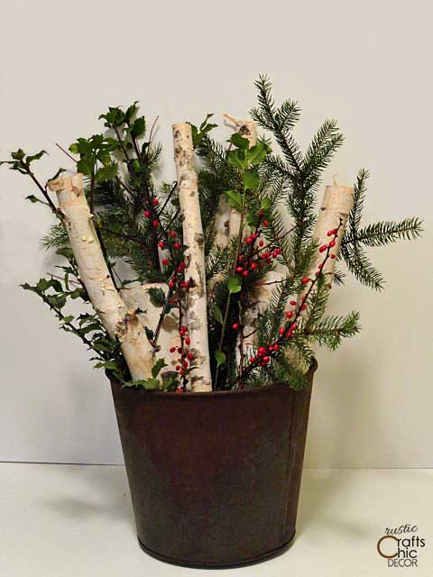 rustic bucket filled with Christmas cuttings