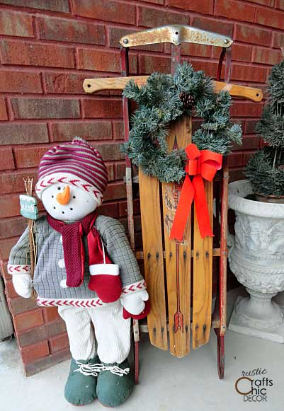 Christmas vintage sled and snowman outside