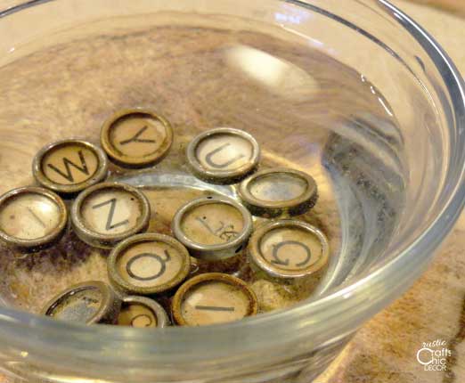 old typewriter keys soaking in water and vinegar