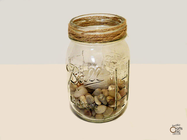 mason jar filled with rocks and tea light