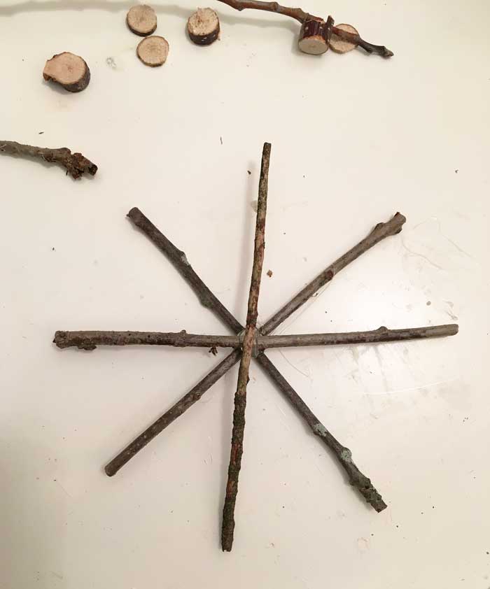 twigs glued together to form snowflake