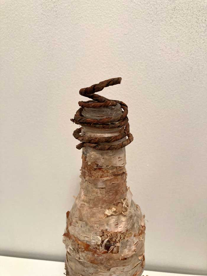 bark covered wire on top of bottle