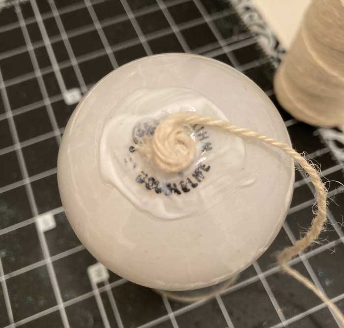 twine circle adhered to light bulb