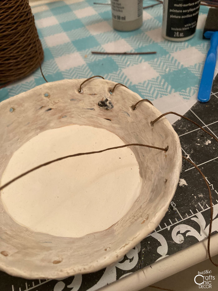 woven wire through clay bowl